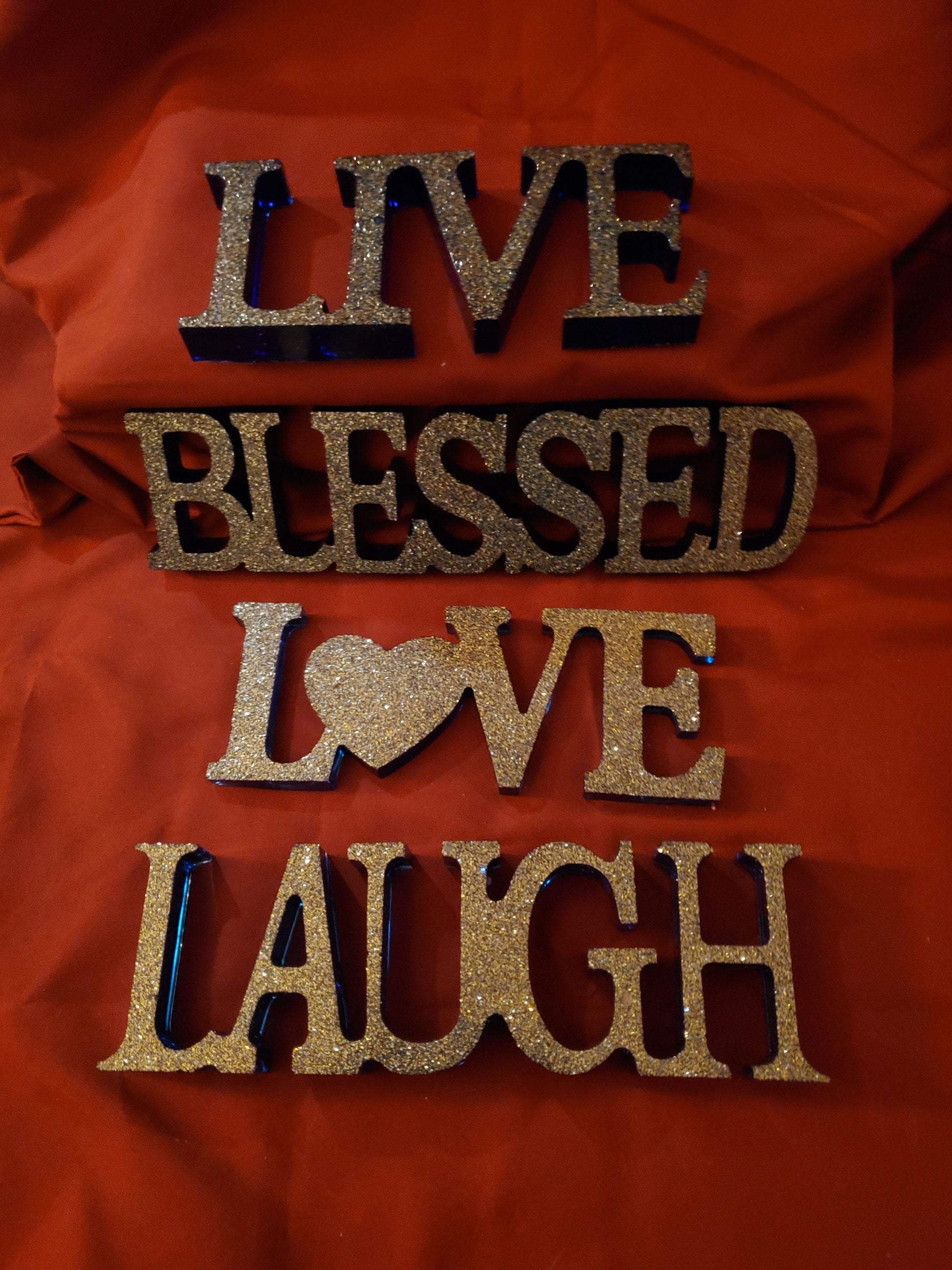 Inspirational signs... "Live," "Laugh," "Love," "Blessed." Resin signs.