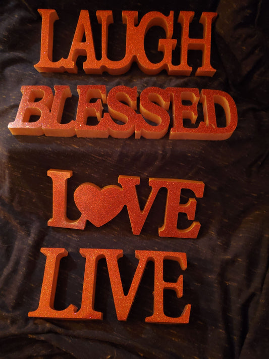 Inspirational signs... "Live," "Laugh," "Love," "Blessed." Resin signs.